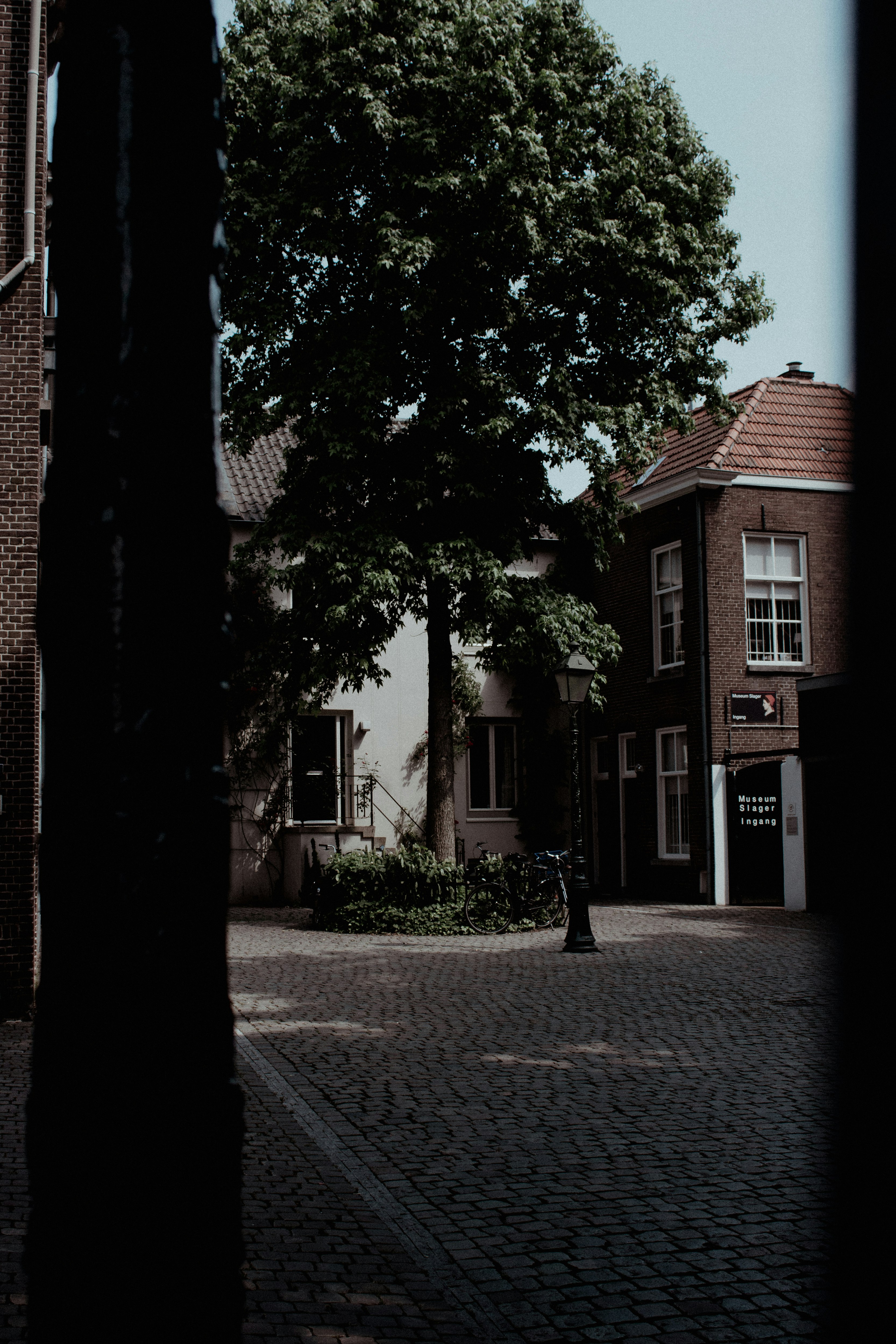 brown brick building near green trees during daytime